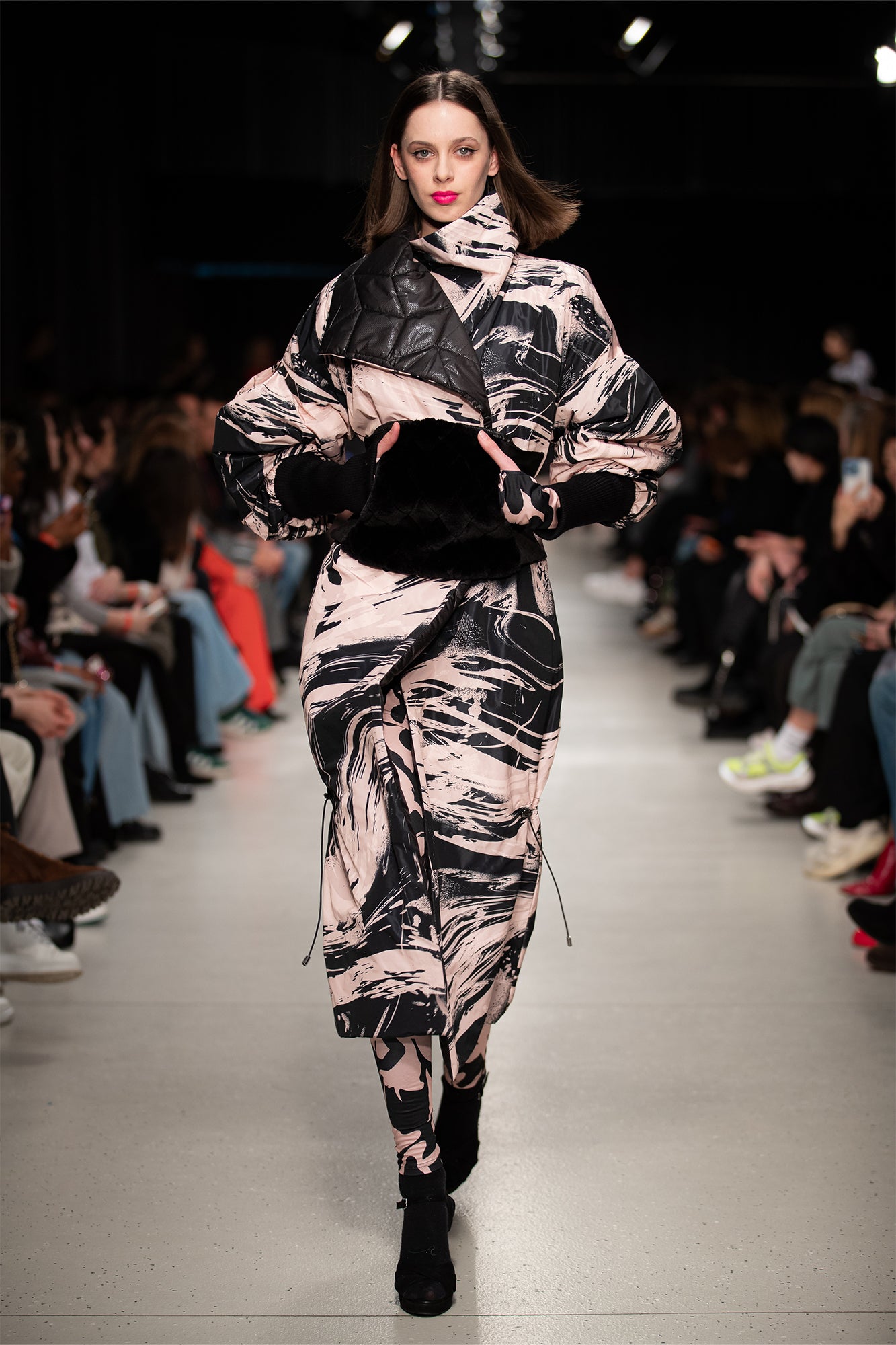 model wearing a printed reversible quilted maxi coat at BCEFW