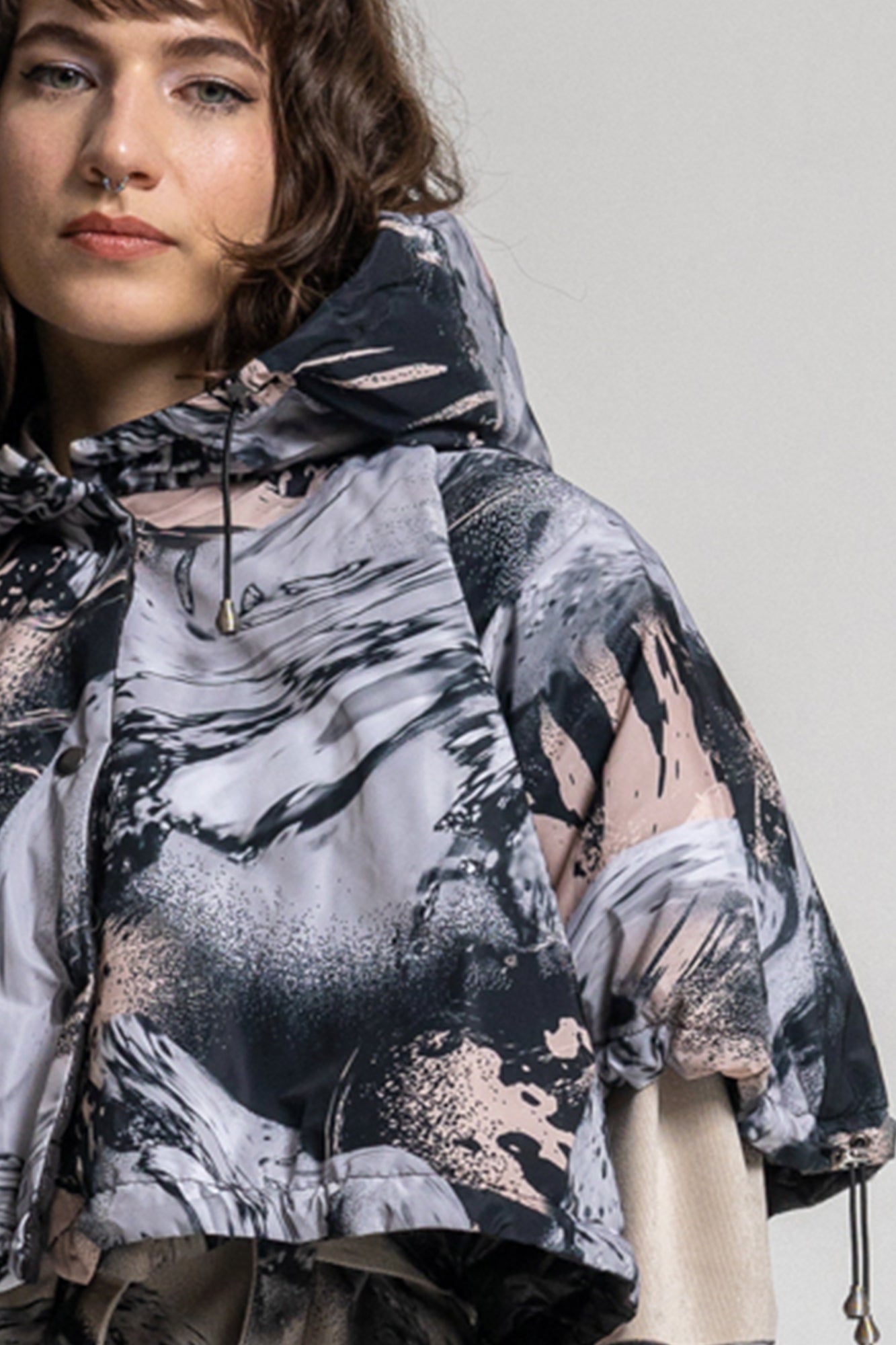hooded cropped puffy jacket with swirling black and pale pink print design