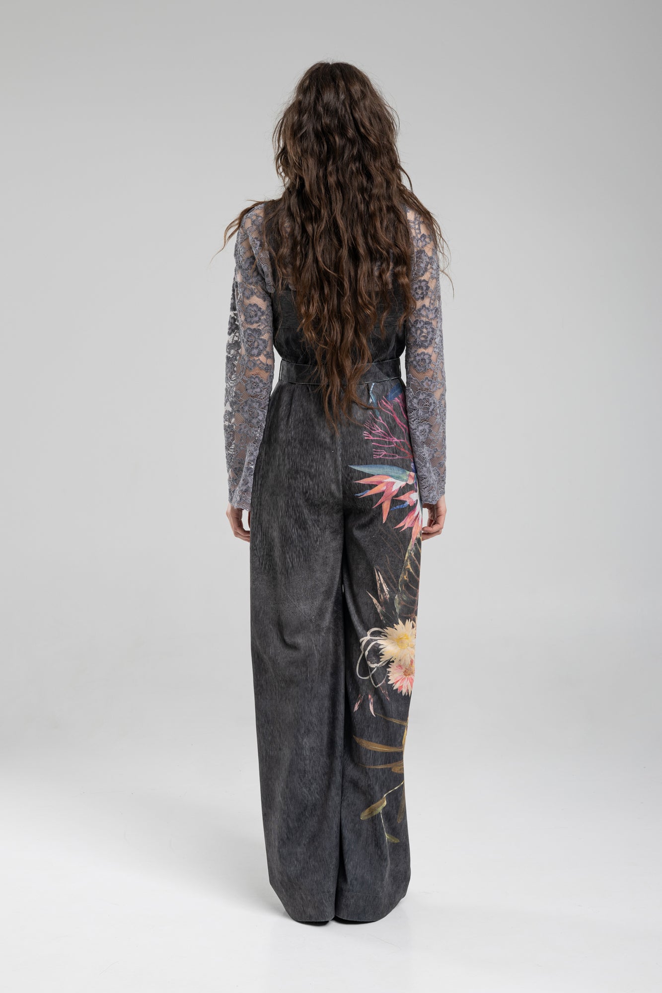 Washed black corduroy jumpsuit with asymmetric floral print