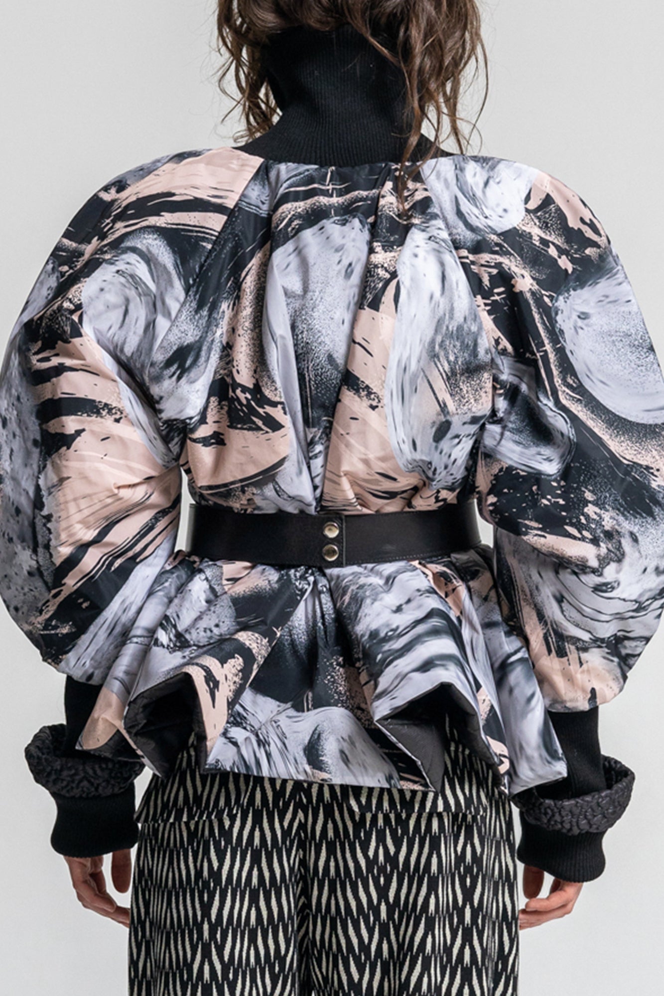 swirling black and pale pink printed puffy jacket