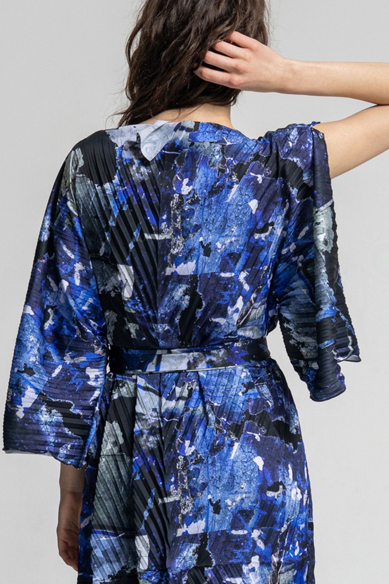 pleated unique printed midi dress creating a flowing silhouette on any figure