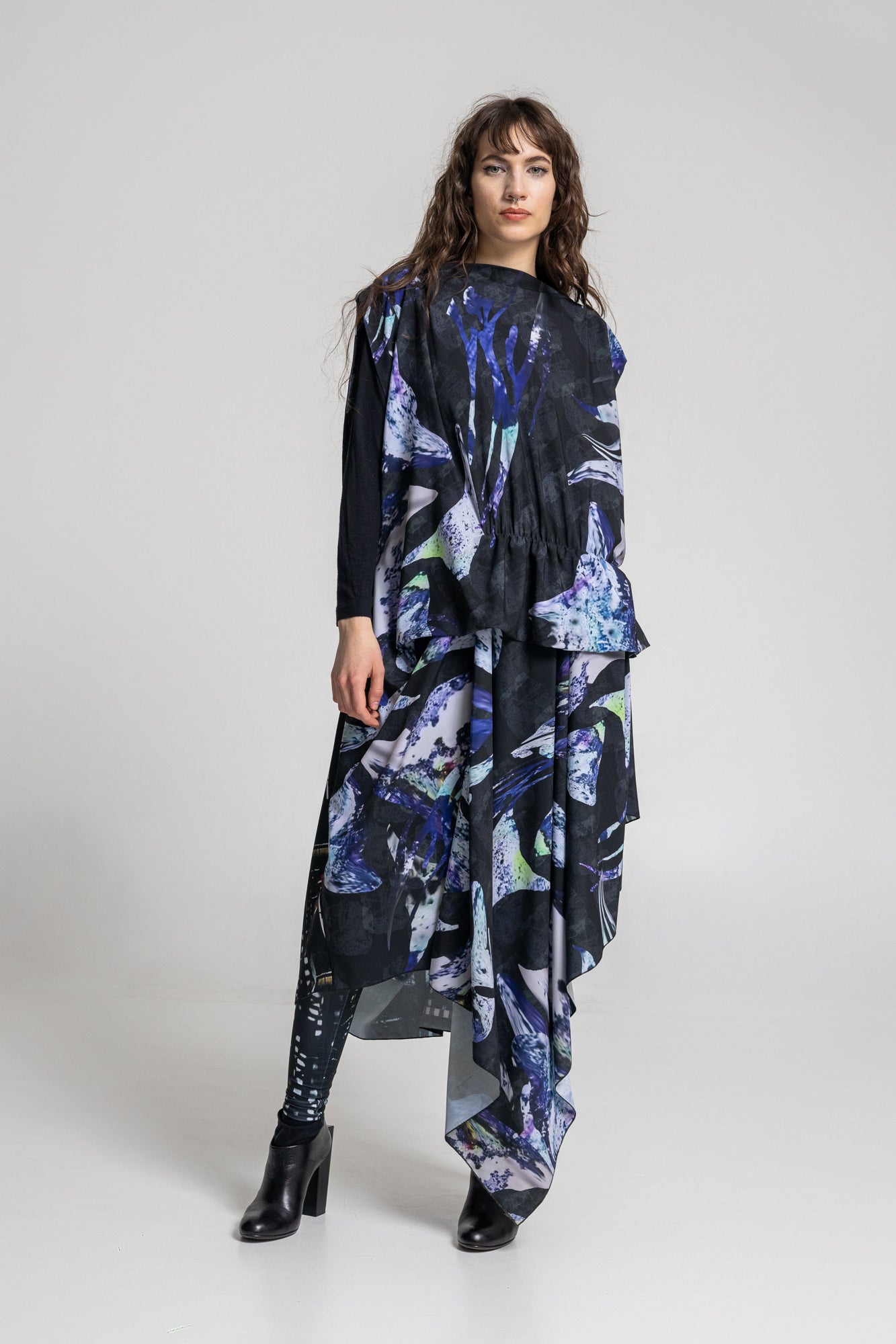 asymmetric maxi cut dress with generous amount of fabric falls down the leg