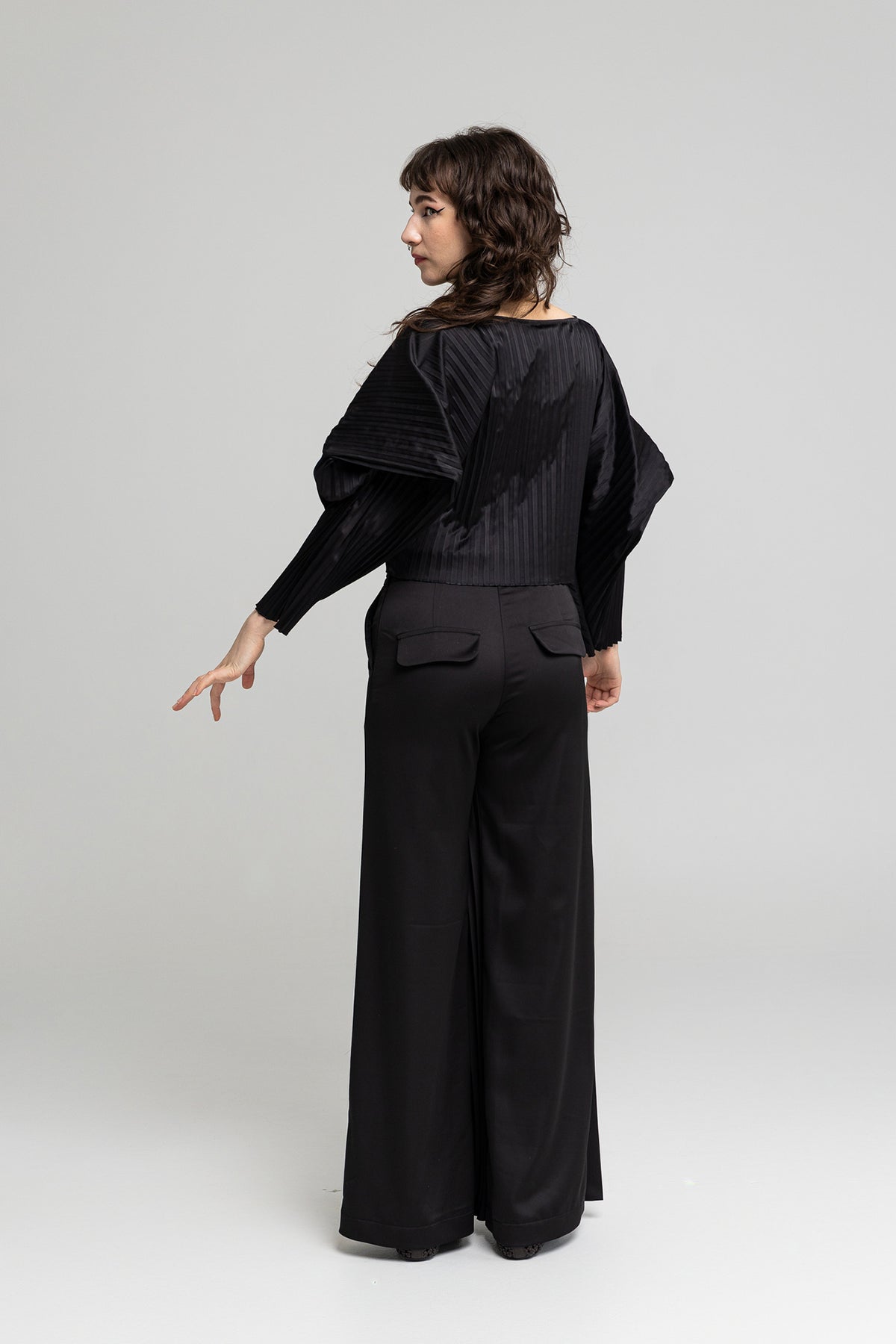 polished fabric asymmetric leg pants with flaps on back artista budapest
