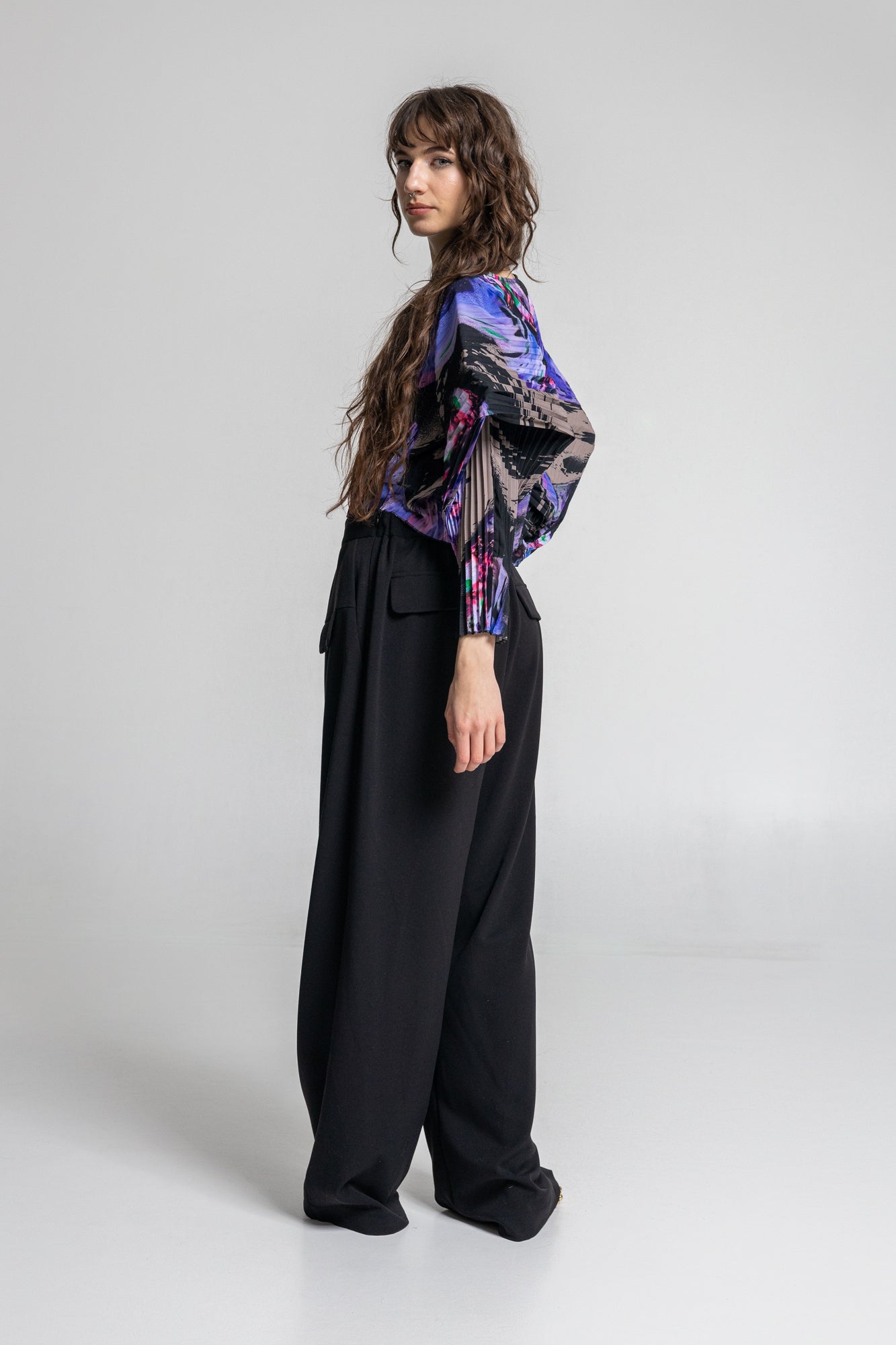 pleated blouse with long geometric shaped sleeves