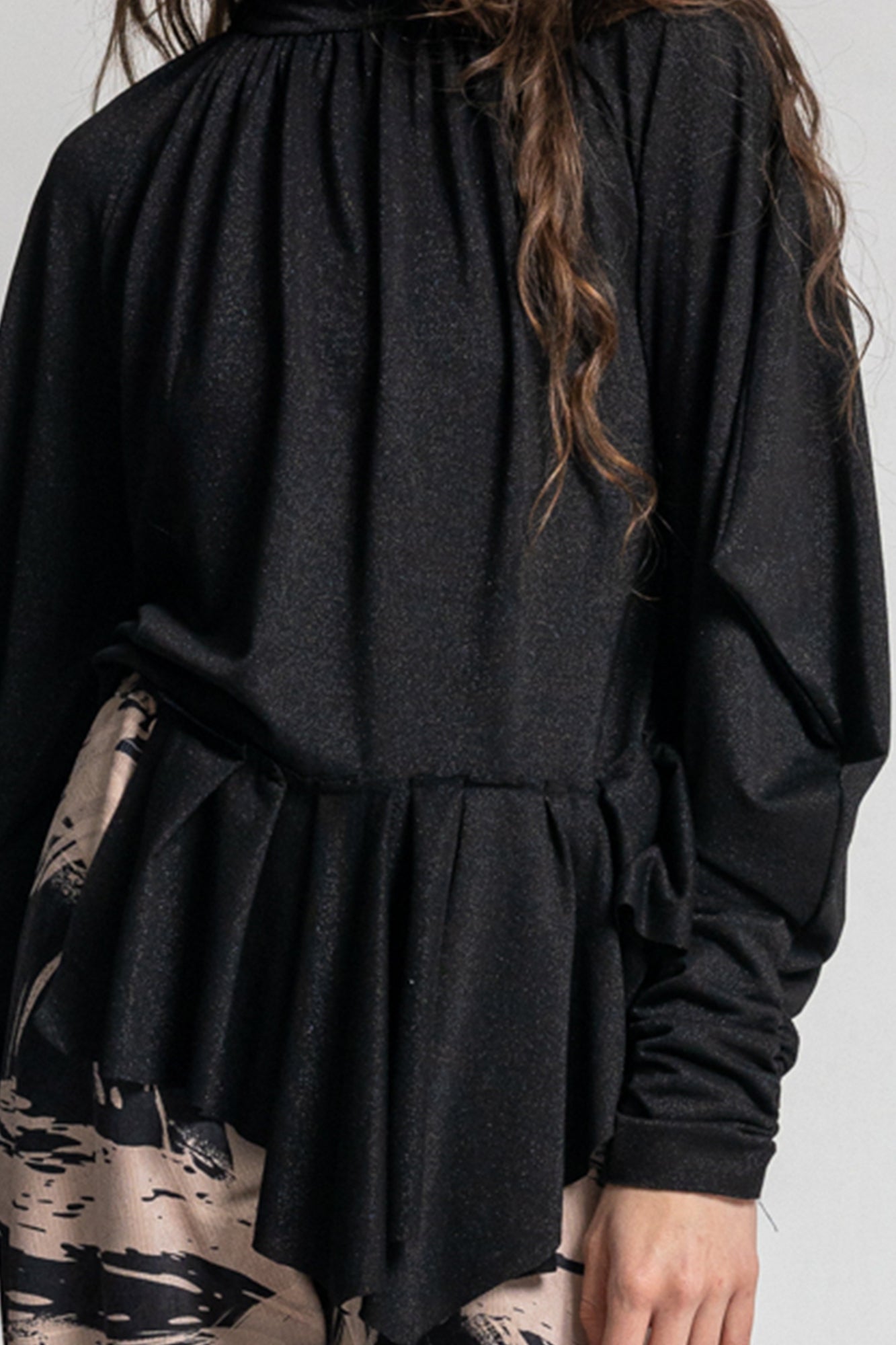 black shiny long sleeve turtleneck with asymmetric hemline
