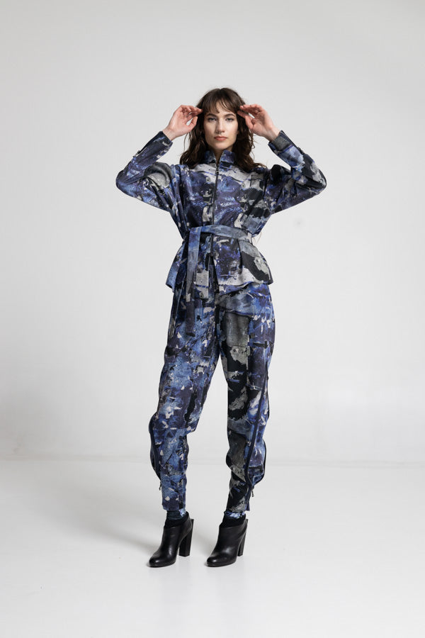 Person wearing a blue camouflage outfit on a white background