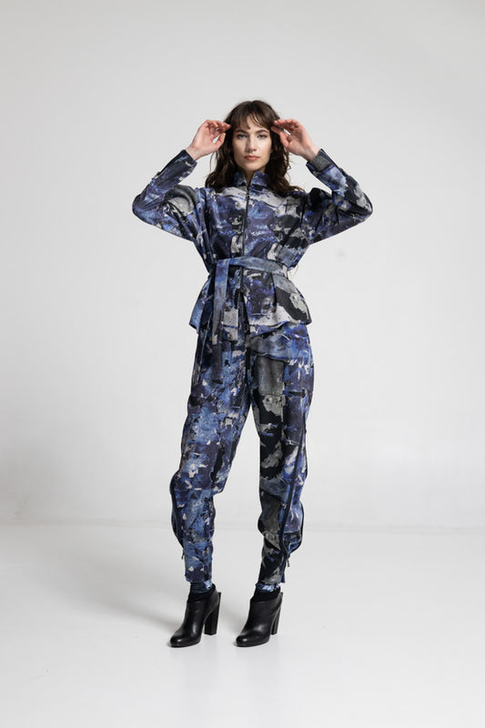 Person wearing a blue camouflage outfit on a white background