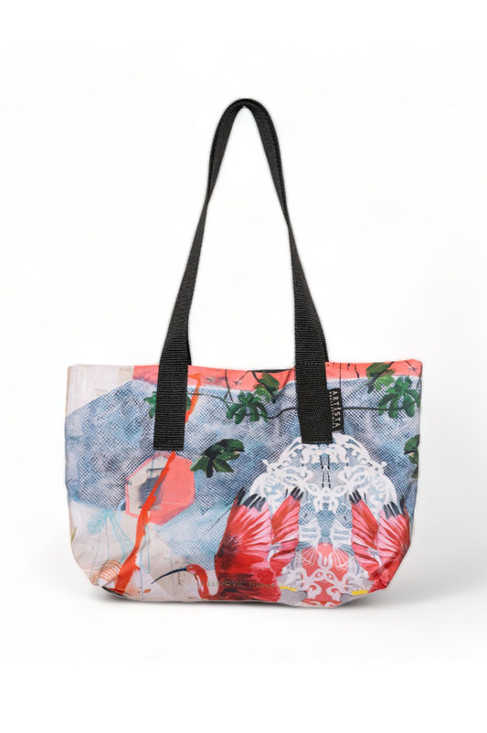 A multicolored printed mini tote bag with black straps featuring a vibrant floral and abstract design.